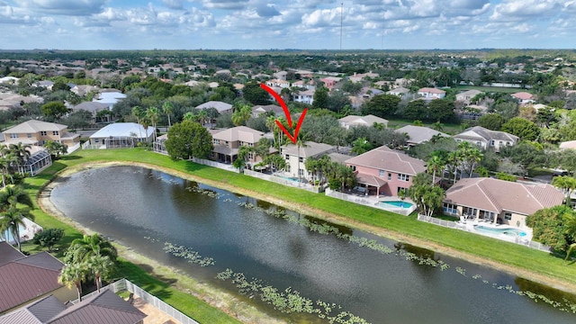 drone / aerial view featuring a residential view and a water view