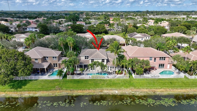 birds eye view of property featuring a water view and a residential view