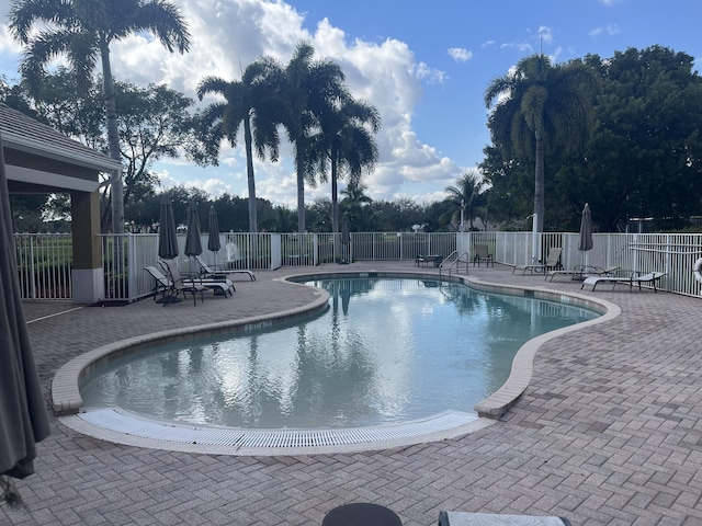 pool featuring a patio and fence