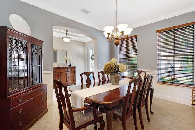 dining room with ornamental molding, a chandelier, and light tile patterned flooring