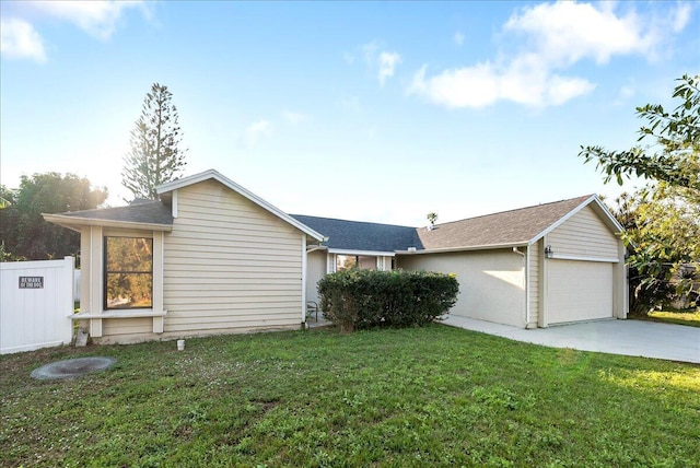 ranch-style house with a garage and a front lawn