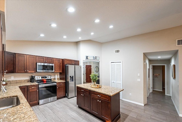 kitchen with sink, dark brown cabinets, stainless steel appliances, high vaulted ceiling, and light stone countertops