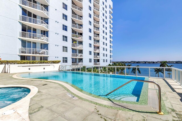 view of swimming pool with a water view