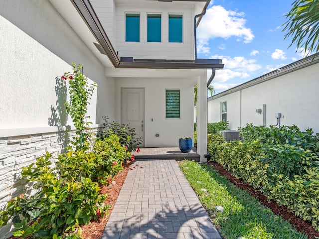 doorway to property featuring central air condition unit