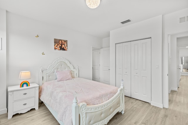 bedroom featuring light hardwood / wood-style floors and a closet