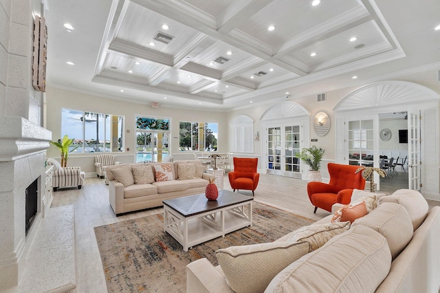 living area featuring coffered ceiling, beamed ceiling, french doors, and crown molding