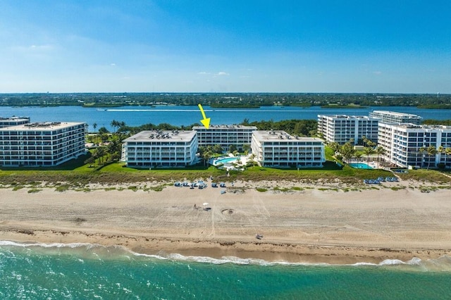 drone / aerial view with a water view and a view of the beach