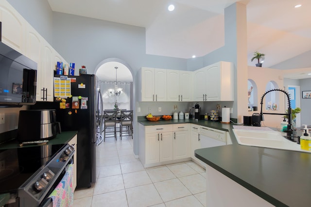 kitchen with sink, stainless steel electric range, white cabinetry, light tile patterned flooring, and a chandelier