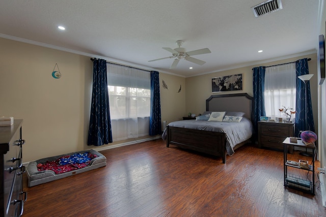 bedroom with dark hardwood / wood-style flooring, crown molding, and ceiling fan