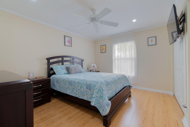 bedroom with ceiling fan, ornamental molding, and light hardwood / wood-style flooring