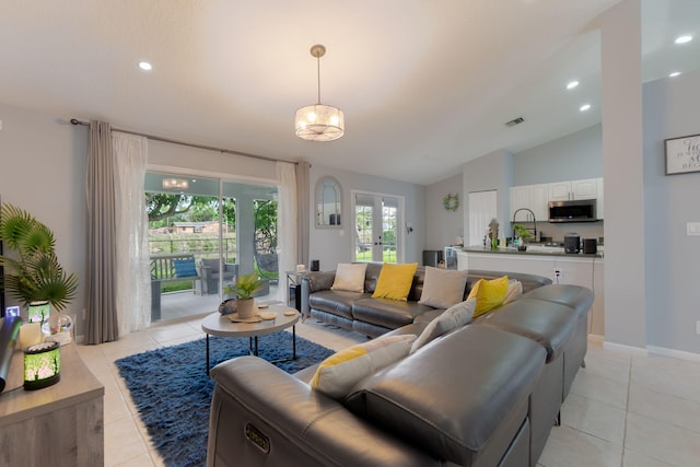 living room with french doors, vaulted ceiling, and light tile patterned floors