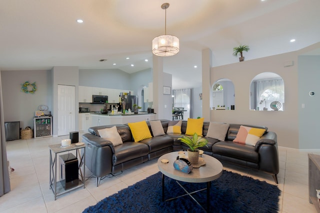 living room with lofted ceiling and light tile patterned floors