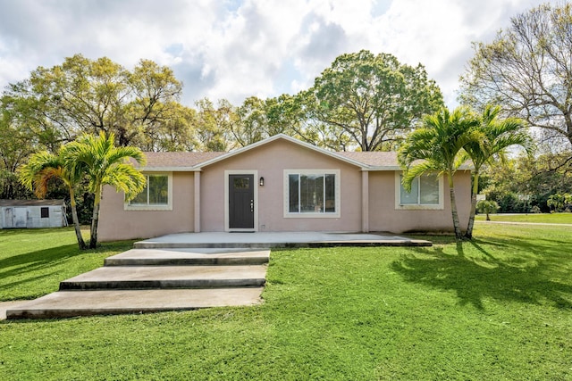 rear view of property with a yard