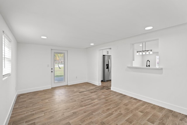 interior space featuring sink and light wood-type flooring