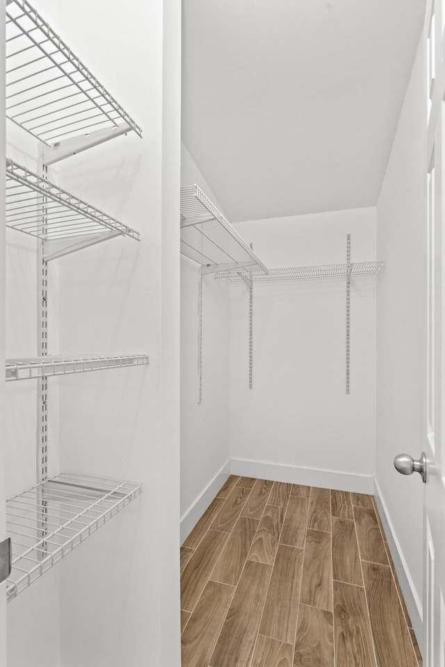 walk in closet featuring hardwood / wood-style floors