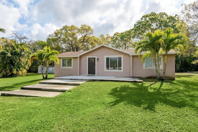 back of house with a lawn and a patio area