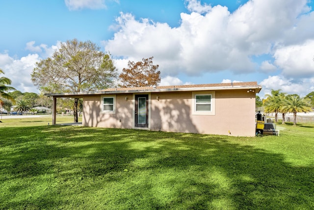 rear view of house with a lawn