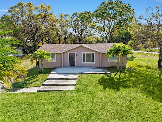 view of front facade with a patio and a front lawn