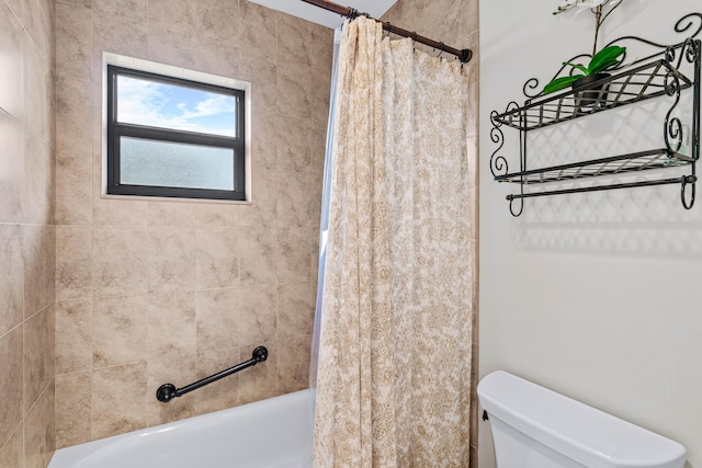 bathroom with shower / tub combo and toilet