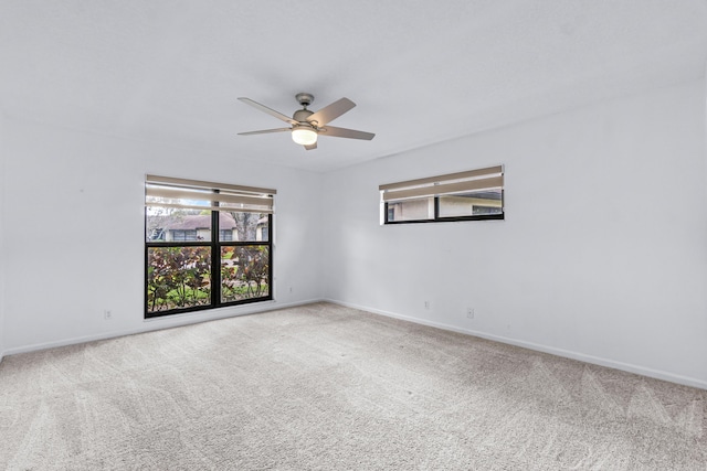 unfurnished room with light colored carpet and ceiling fan