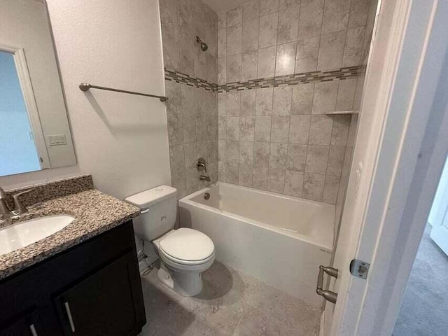 full bathroom featuring tiled shower / bath combo, vanity, and toilet