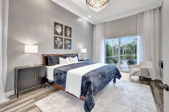 bedroom featuring crown molding, access to exterior, a chandelier, and hardwood / wood-style flooring