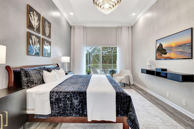 bedroom with ornamental molding, wood-type flooring, and a notable chandelier