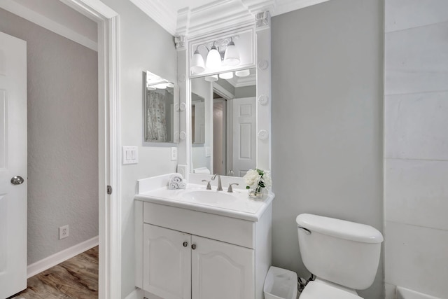 bathroom with vanity, hardwood / wood-style floors, crown molding, and toilet