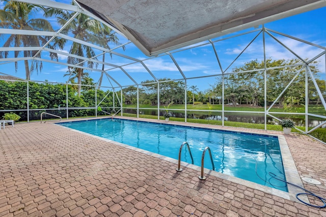 view of pool featuring a water view, a lanai, and a patio