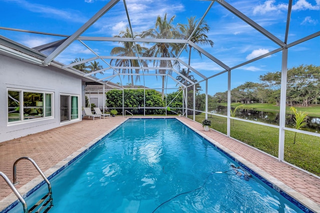 view of swimming pool with a water view, a patio area, glass enclosure, and a lawn