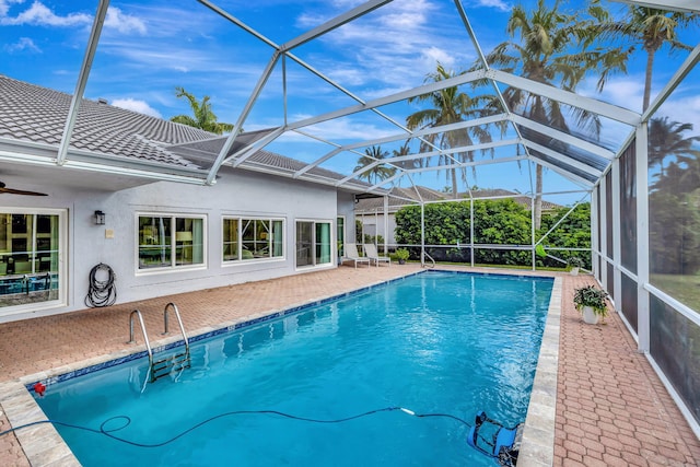 view of pool with a patio area and glass enclosure