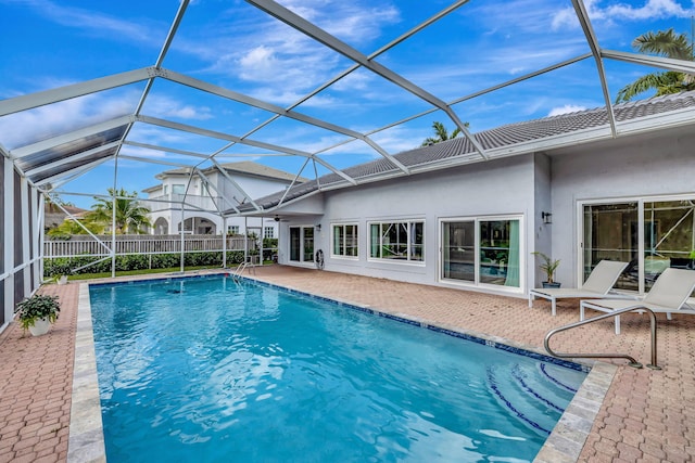 view of pool with a patio and a lanai