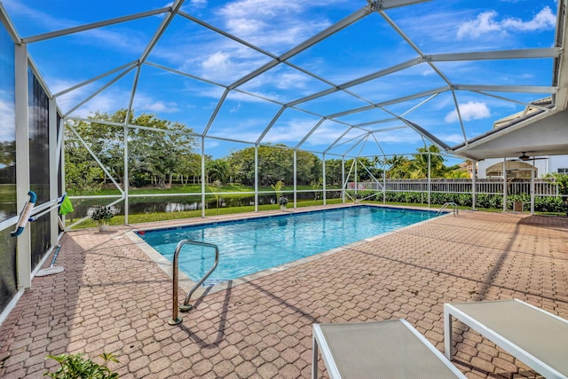 view of pool featuring a water view, a lanai, and a patio area