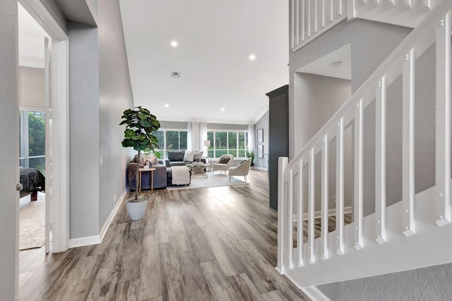 interior space featuring hardwood / wood-style flooring and ornamental molding