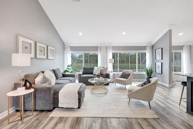 living room featuring ornamental molding, vaulted ceiling, and light hardwood / wood-style floors