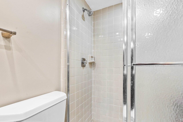 bathroom with walk in shower and toilet