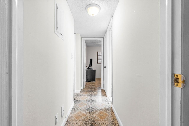 hallway featuring a textured ceiling