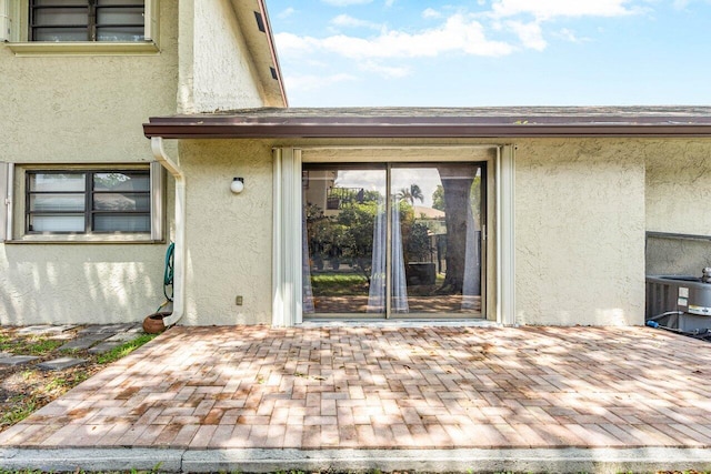 entrance to property featuring central AC and a patio area