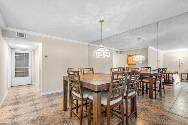 dining room with crown molding and a textured ceiling