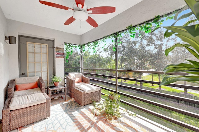 sunroom with a healthy amount of sunlight and ceiling fan