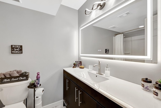 bathroom featuring a shower with curtain, vanity, and toilet