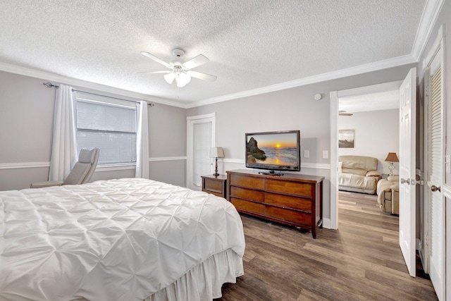 bedroom with ceiling fan, crown molding, wood-type flooring, and a textured ceiling