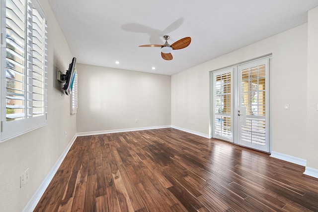 spare room featuring ceiling fan, dark wood-type flooring, and french doors