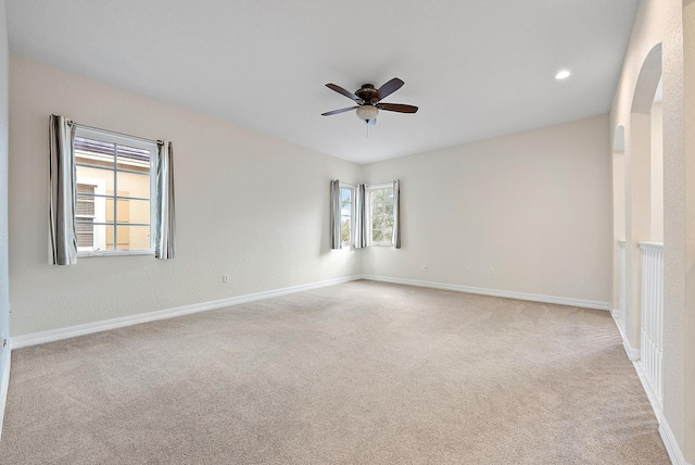 carpeted spare room with ceiling fan