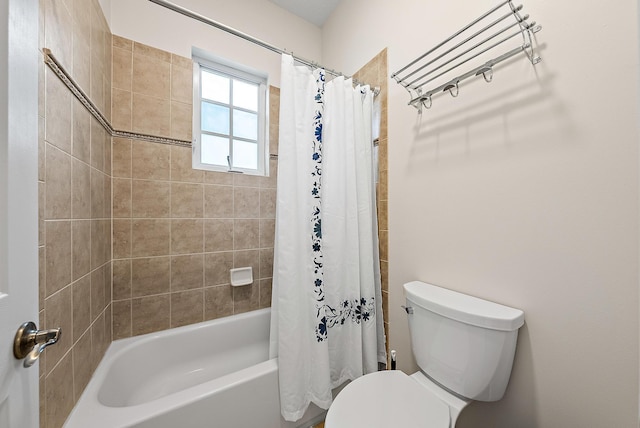 bathroom featuring shower / tub combo with curtain and toilet