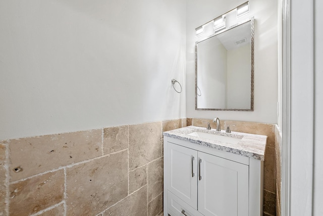 bathroom with tile walls and vanity