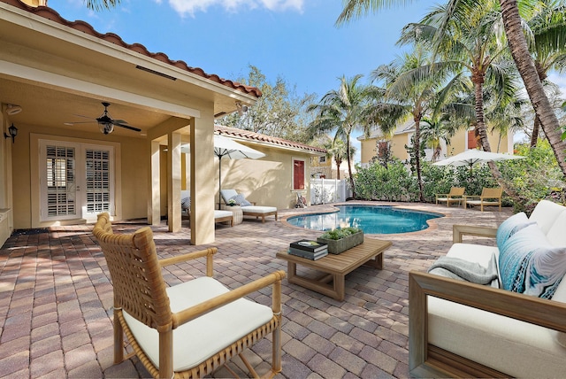 view of pool featuring french doors, a patio, an outdoor hangout area, and ceiling fan