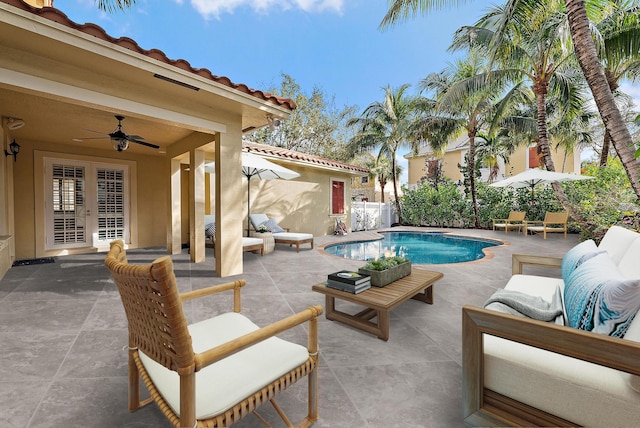 view of pool featuring french doors, an outdoor living space, a patio, and ceiling fan