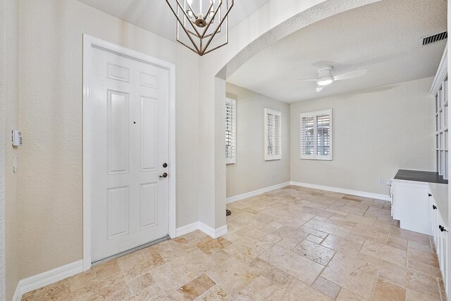 entrance foyer with ceiling fan and a textured ceiling