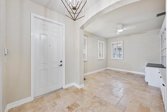 entrance foyer with ceiling fan and a textured ceiling